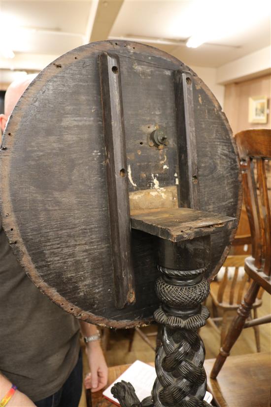 A carved tripod table W.55cm